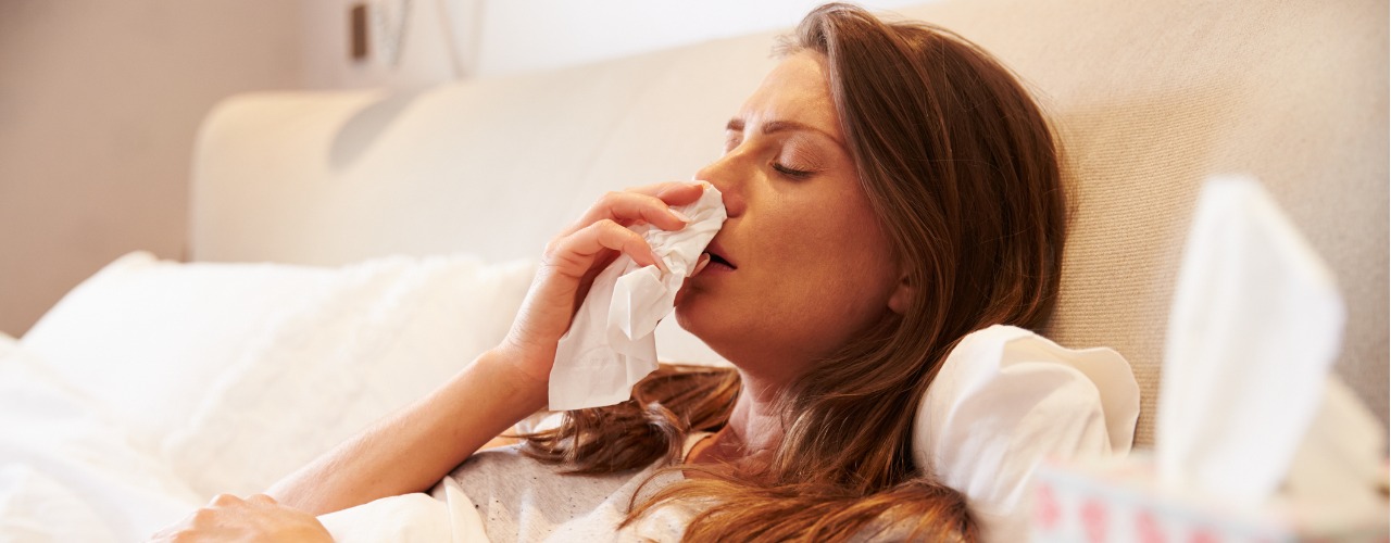 attachment-woman-suffering-from-cold-lying-in-bed-with-tissue-picture-id485932628