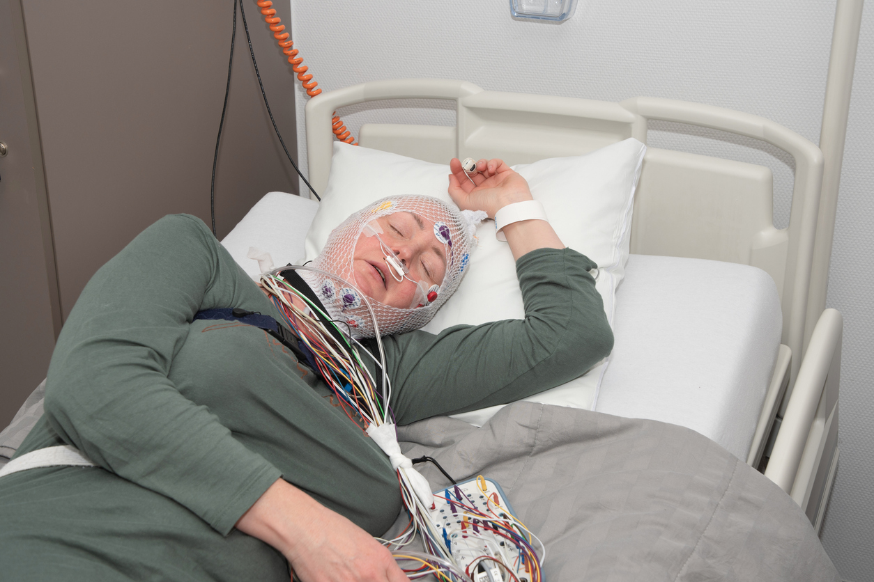 middle-aged-woman-measuring-brain-waves-examining-polysomnography-in-sleep-lab