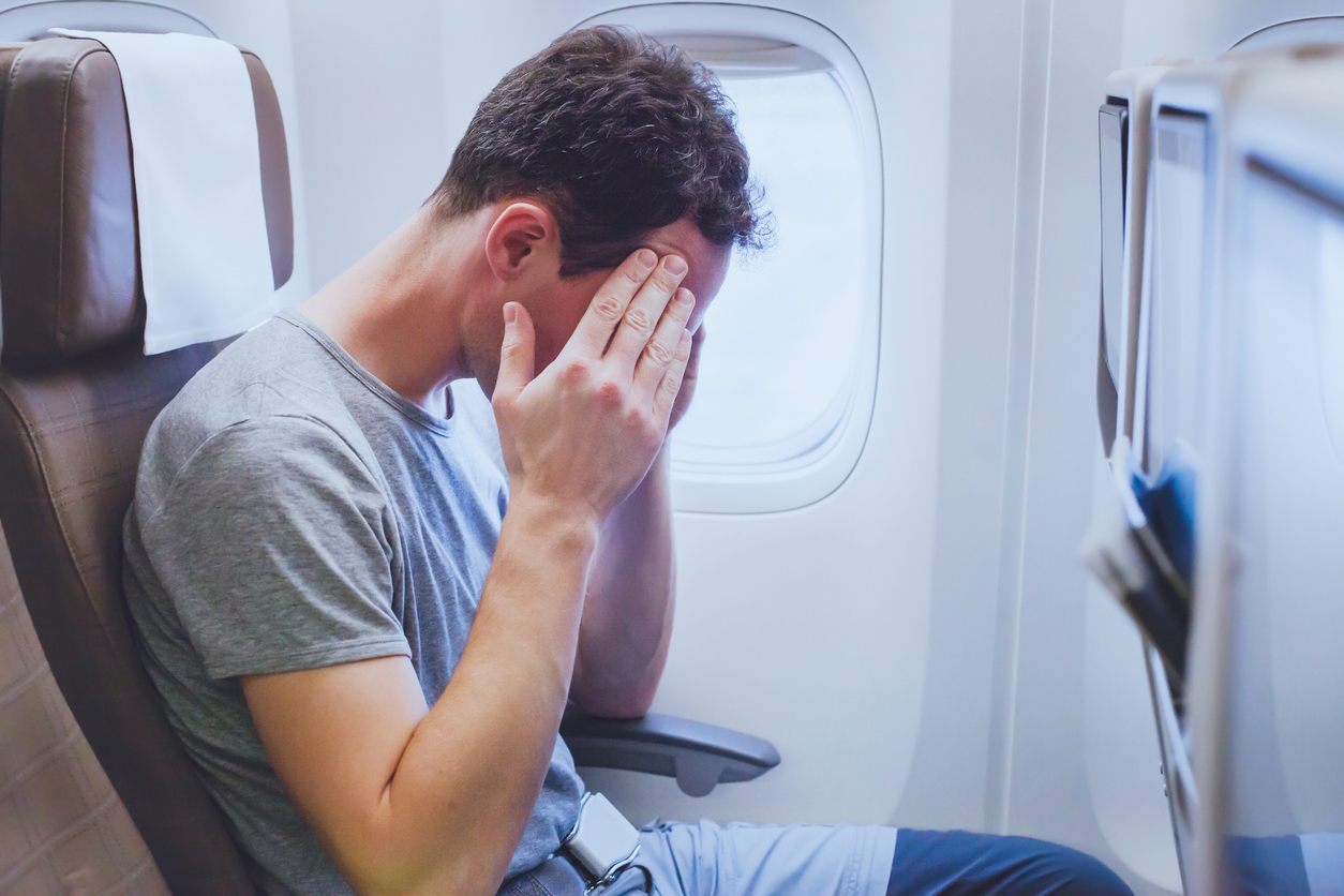 headache-in-the-airplane-man-passenger-afraid-and-feeling-bad-during-flight-fear